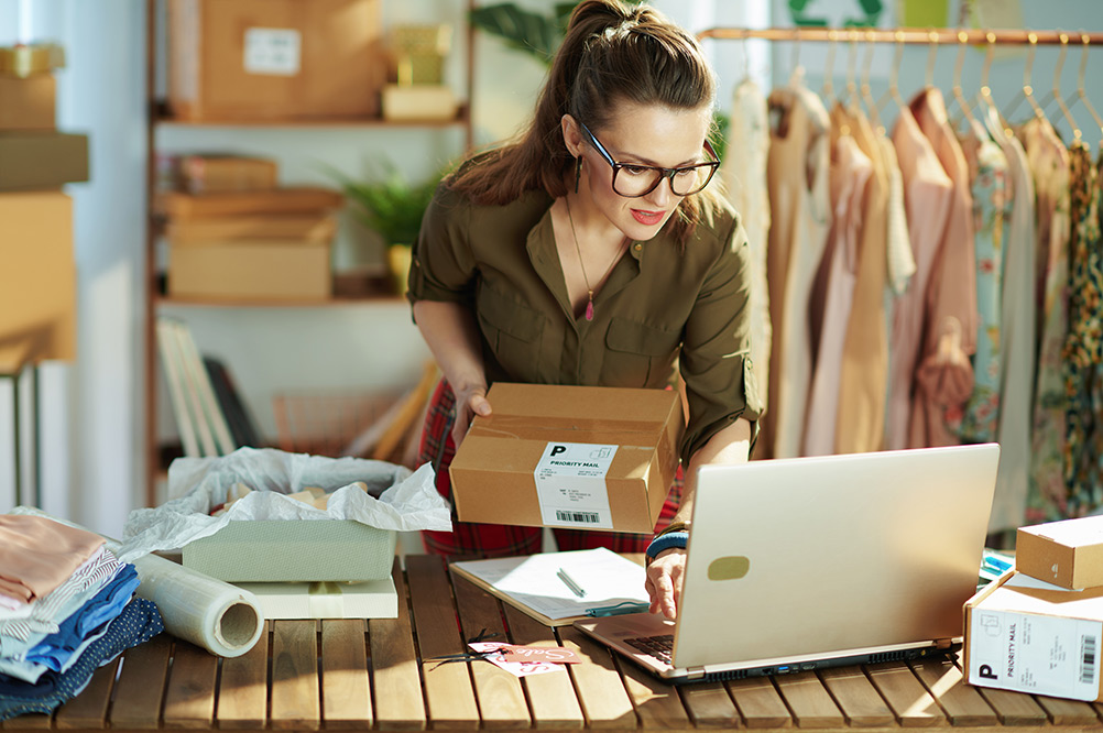 Business women in retail store using laptop 