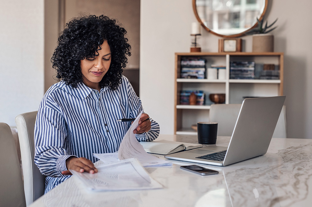 Woman reading paperwork at desk